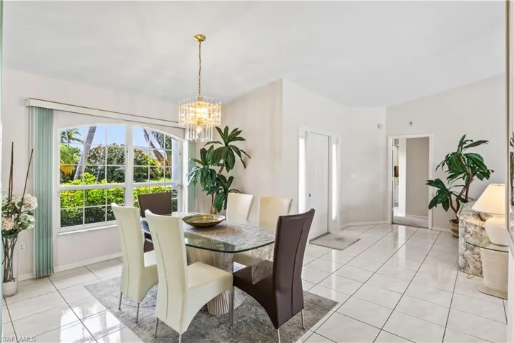 Dining space featuring a notable chandelier and light tile floors