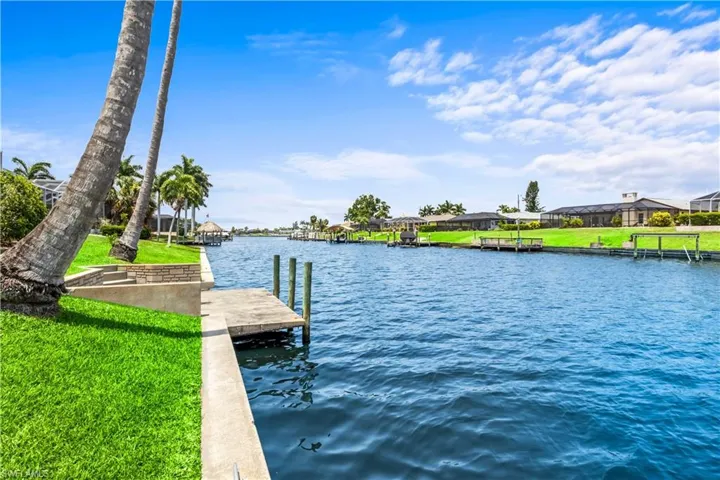 Dock area featuring a water view and a yard