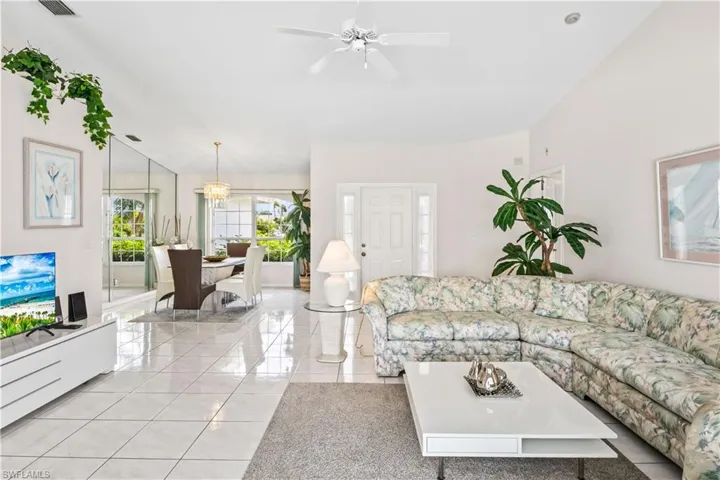 Living room featuring ceiling fan and light tile floors
