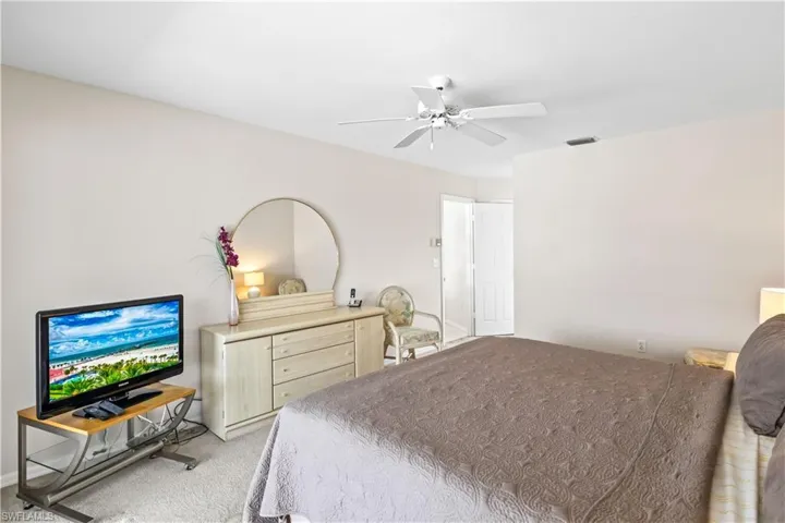 Bedroom featuring light colored carpet and ceiling fan