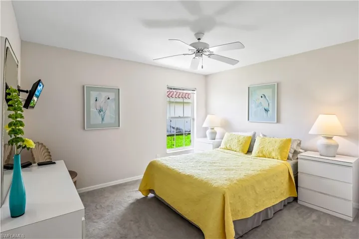 Carpeted bedroom with ceiling fan