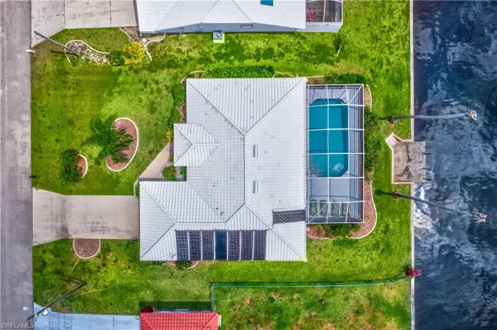 Birds eye view of property with a water view