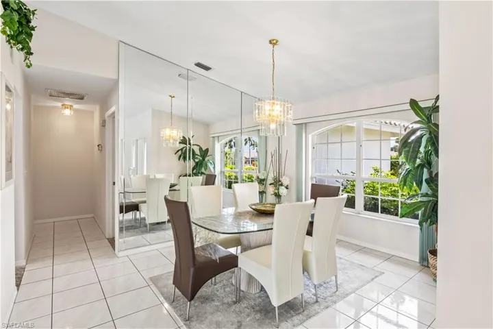 Dining room featuring light tile floors and an inviting chandelier