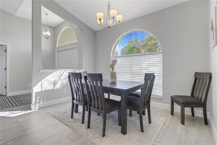 Dining space featuring light hardwood / wood-style floors and a notable chandelier