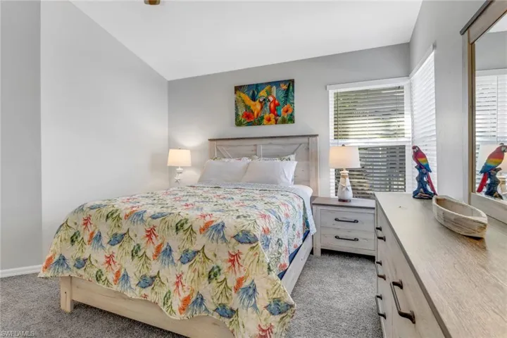 Carpeted bedroom with vaulted ceiling