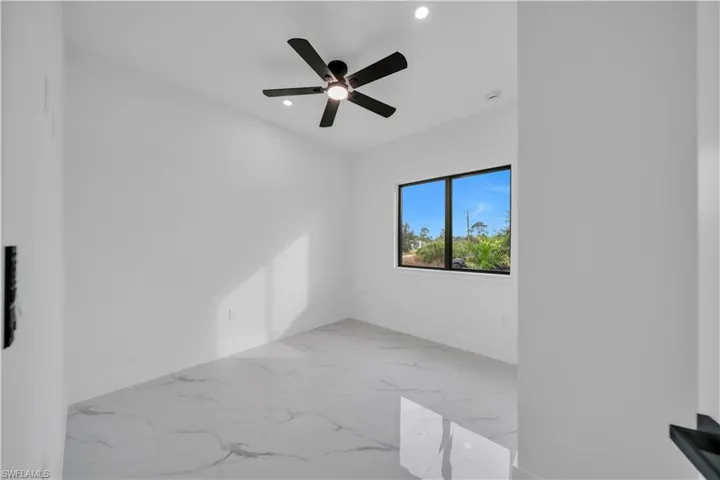 Unfurnished room with light marble finish floors, recessed lighting, and ceiling fan