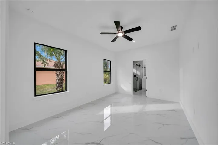 Spare room featuring light marble finish floors, ceiling fan, and recessed lighting