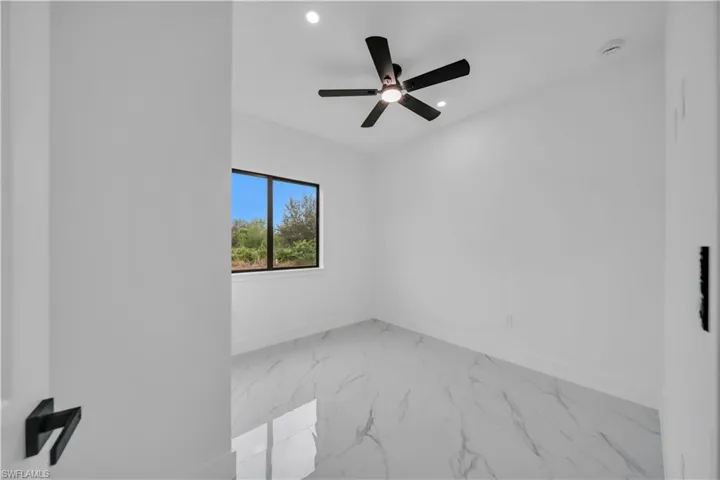Spare room featuring marble finish flooring, recessed lighting, and ceiling fan