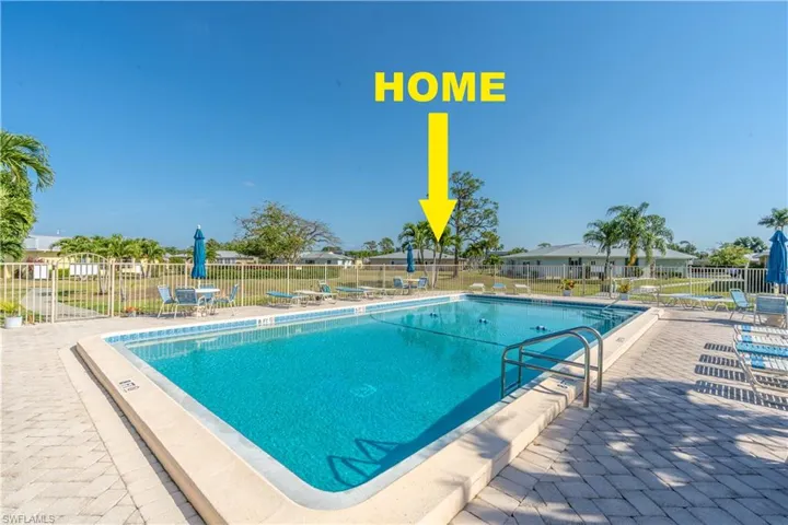 Community pool featuring a patio and fence