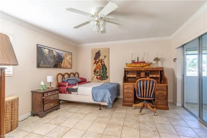 Bedroom featuring access to outside, ornamental molding, baseboards, a ceiling fan, and light tile patterned flooring