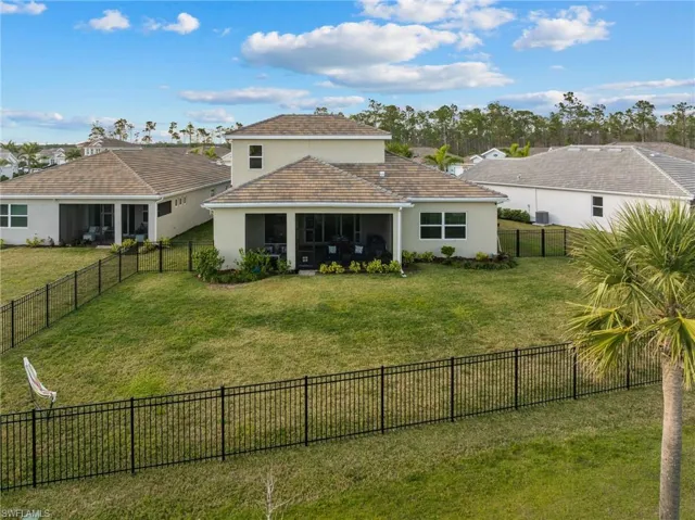 Back of house with a lawn