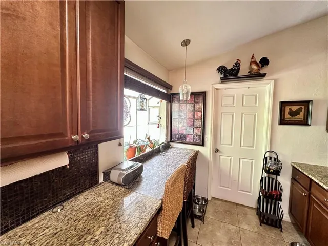 Kitchen featuring hanging light fixtures and light tile patterned flooring