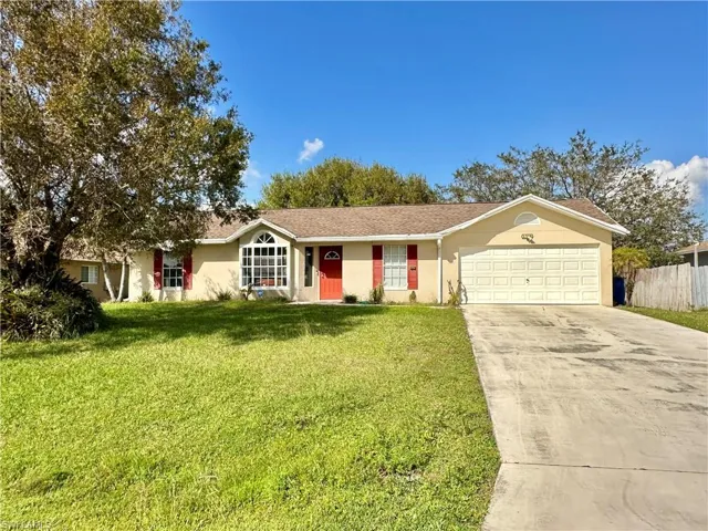 Ranch-style house with a garage and a front yard