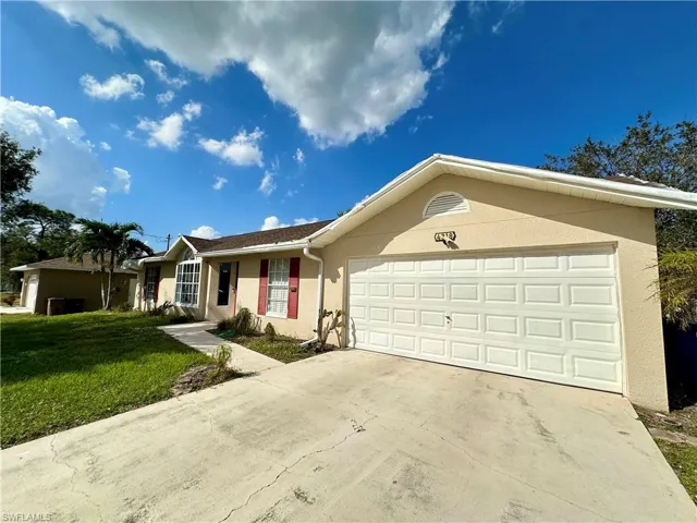 Ranch-style home with a garage and a front yard