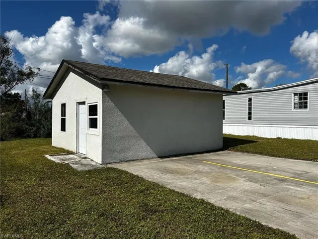 View of side of home featuring a yard