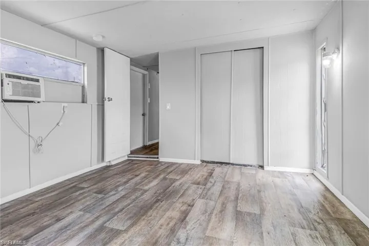 Unfurnished bedroom with a closet and hardwood / wood-style floors