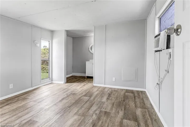 Empty room featuring wood-type flooring