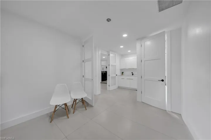 Corridor with recessed lighting and light tile patterned floors