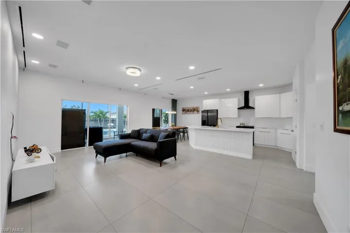 Living area with recessed lighting and baseboards
