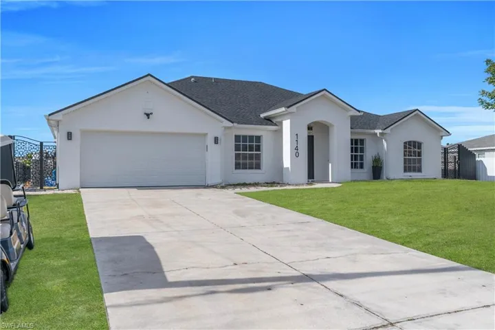 Single story home with a shingled roof, stucco siding, driveway, and an attached garage