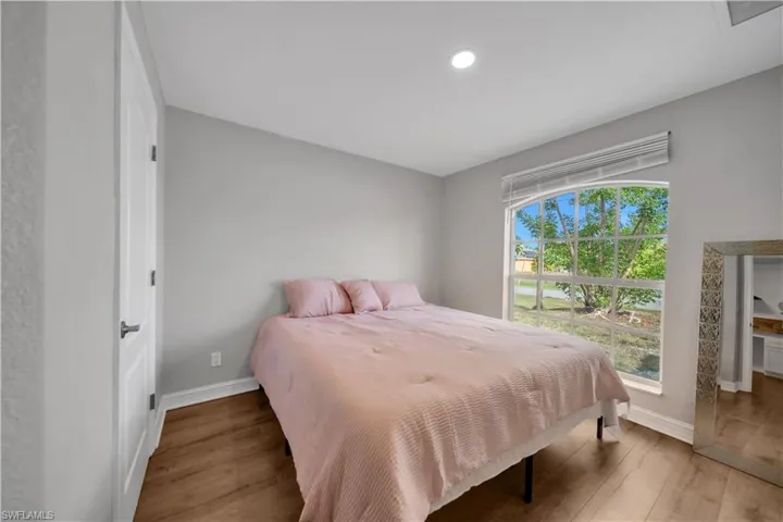 Bedroom featuring light wood-style floors and baseboards