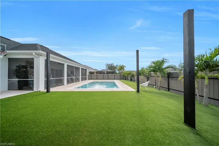 Fenced backyard with a sunroom and a patio