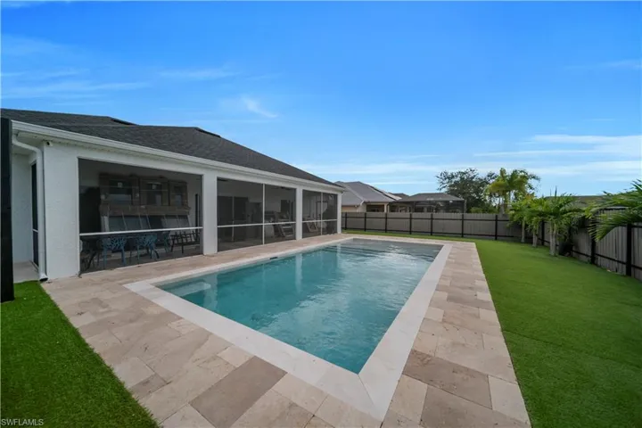 View of swimming pool featuring a fenced backyard, a sunroom, and a patio