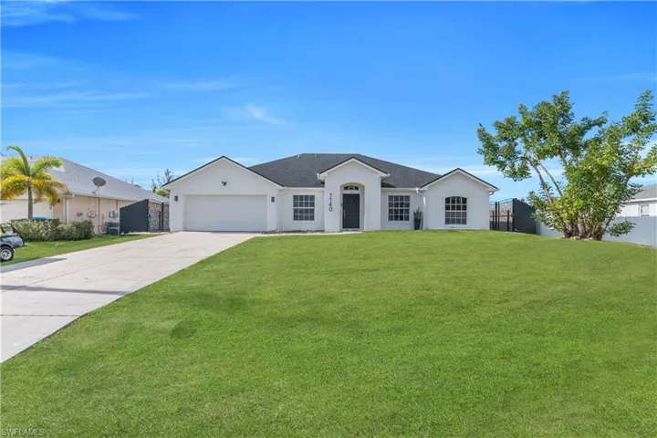 Ranch-style house featuring concrete driveway, stucco siding, and a garage