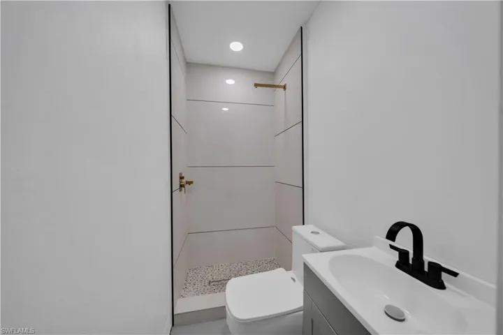 Full bath featuring vanity, a shower stall, and recessed lighting