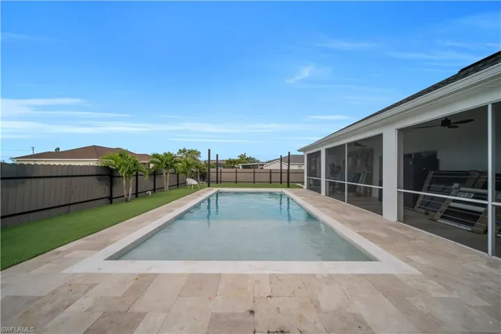 View of pool featuring a fenced backyard, a patio area, and a sunroom