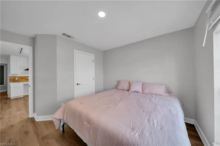 Bedroom featuring baseboards and wood finished floors