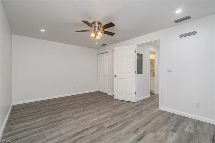 Unfurnished bedroom featuring ceiling fan, recessed lighting, light wood-style flooring, a closet, and electric panel