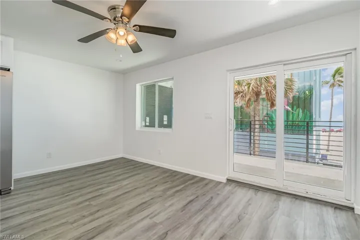 Empty room featuring ceiling fan and light wood finished floors