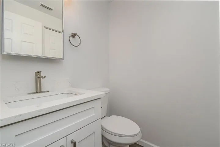 Half bath with vanity and toilet