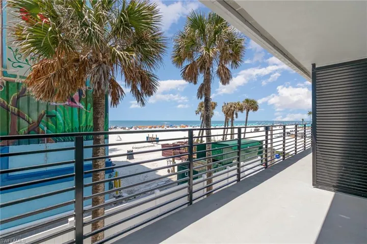 Balcony with view of water and beach