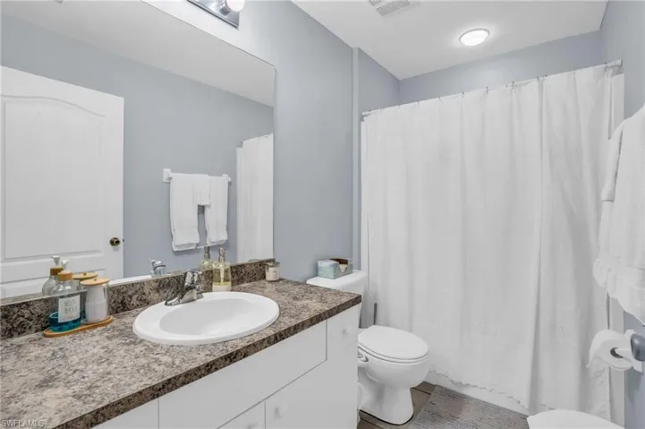 Bathroom with vanity, tile patterned flooring, and toilet