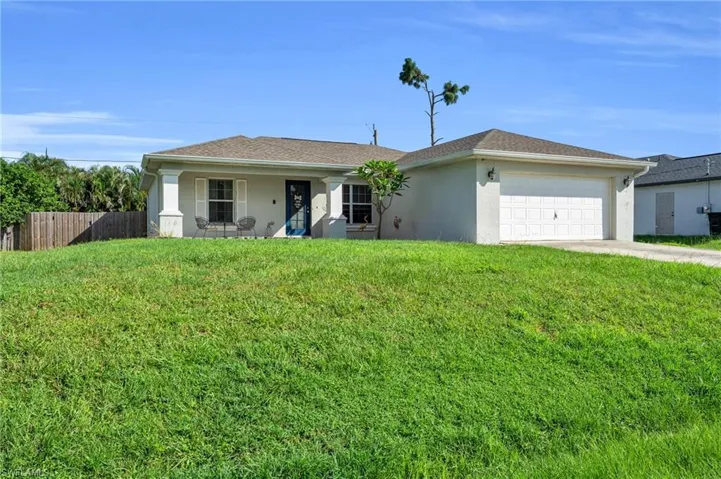 Ranch-style home with a garage and a front yard