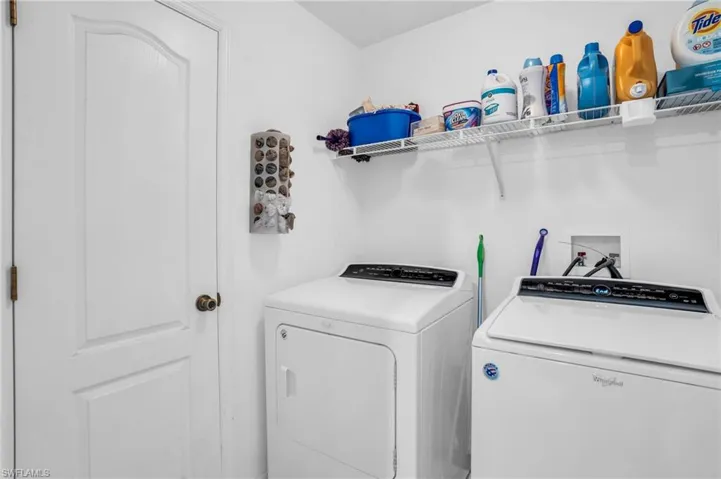 Clothes washing area featuring washer and clothes dryer