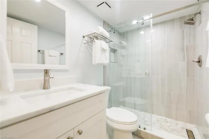 Bathroom with vanity and a stall shower