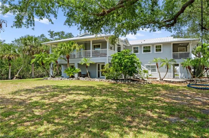 Back of property featuring a yard
