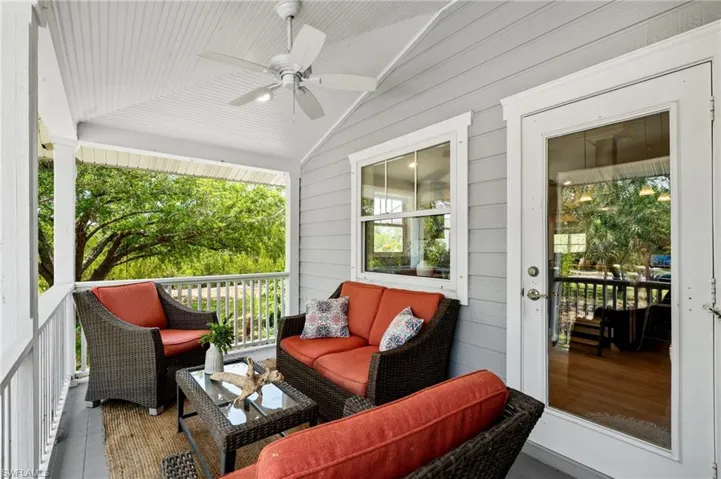 Sunroom / solarium with ceiling fan, vaulted ceiling, and a balcony
