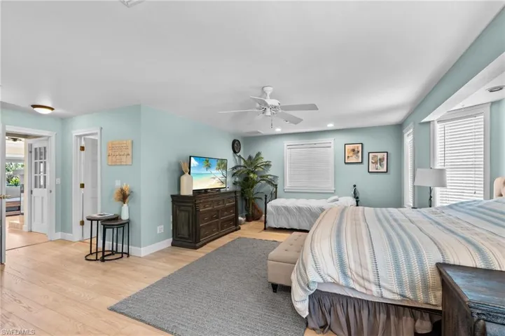 Bedroom featuring light wood-type flooring, ceiling fan, and recessed lighting