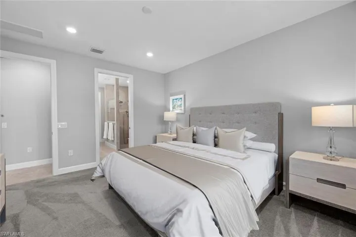Master bedroom looking into en-suite bath ***Bedspread virtually staged***