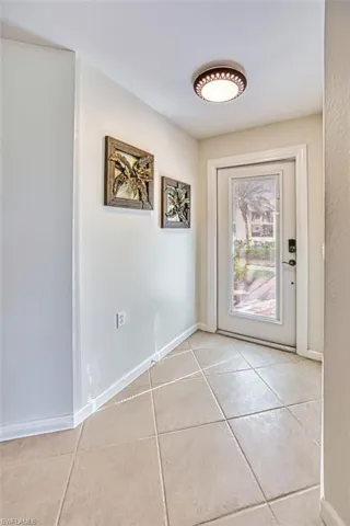 Entryway featuring baseboards and tile patterned floors