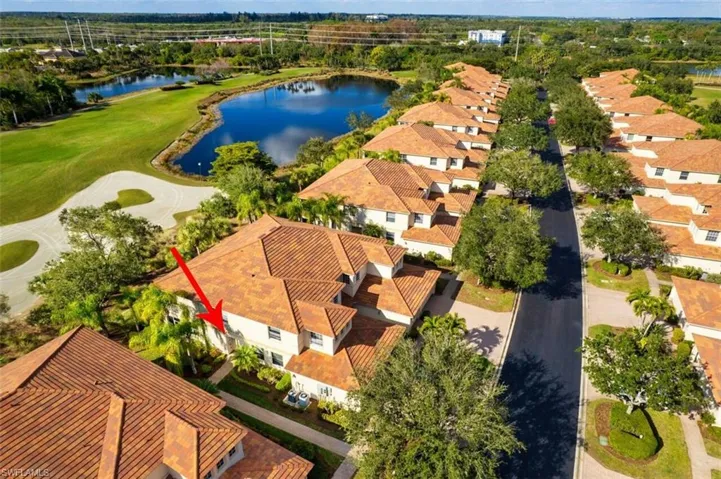 Aerial perspective of suburban area with a large body of water and a golf club