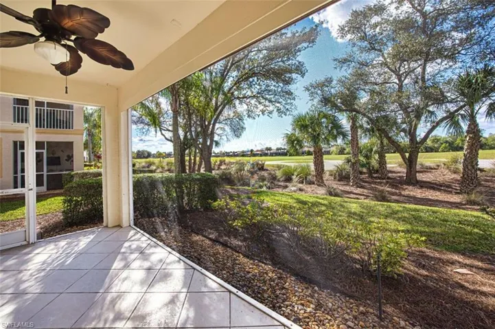 View of patio featuring a ceiling fan and a sunroom