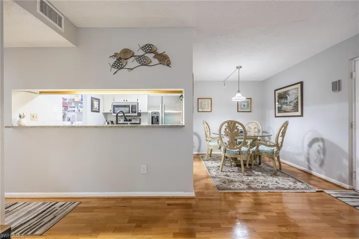Dining room featuring hardwood / wood-style flooring and a textured ceiling