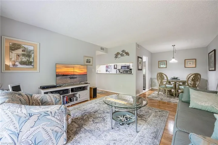 Living room featuring light hardwood / wood-style flooring and a textured ceiling
