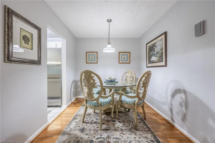 Dining space featuring light hardwood / wood-style flooring and a textured ceiling
