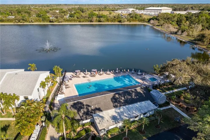 Birds eye view of property with a water view